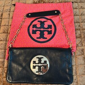 Tory Burch bombe reva black with gold clutch. Dust bag included.
